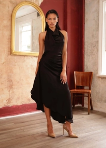 Detail of elegant black satin halter neck dress with draped cowl neckline and side pleats