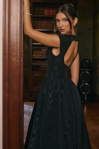 Detail of elegant backless cutout on black sleeveless dress with a flared skirt