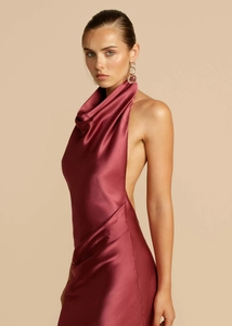 Detail of elegant wine red satin dress showing the halter cowl neck and smooth fabric texture