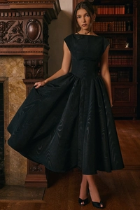 Detail of elegant black moiré silk midi dress with boat neck and voluminous A-line skirt