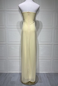 Close-up of invisible zipper detail on the back of light yellow tube maxi dress