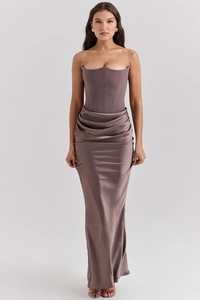 Close-up of elegant satin corset dress showing bone structure and draped hip pleats
