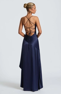 Detailed back view of navy blue satin dress with cross-straps and backless design