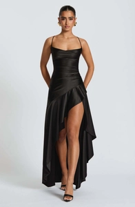 Detail of elegant black satin evening dress with ruffled high-low hem and sleek spaghetti straps