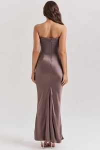 Detailed back view of a satin strapless evening dress with fishtail hem and zipper closure