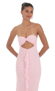 Detail view of pink tube dress featuring hollow-out twist knot and layered ruffle design