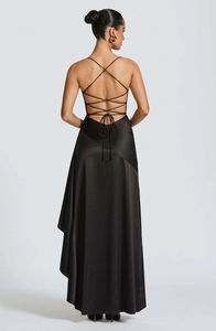 Detail of cross-back tie design on backless black satin evening dress with silky texture