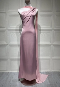 Detail of elegant satin evening gown with one-shoulder design and flowing chiffon sash