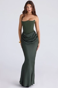 Macro detail of emerald green satin dress featuring boned corset and draped pleats