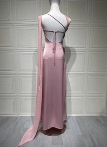 Detail of pink satin fishtail dress featuring thin straps and elegant open back design
