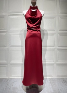 Detail of red satin halter neck dress featuring pleated cowl neckline and slim fit design