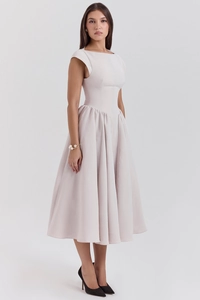Detail of elegant sleeveless backless dress in light pink with a pleated A-line skirt