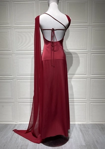 Detail of deep red satin evening gown featuring an open back with delicate lace-up straps