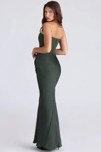 Detail view of smooth satin fabric and structured corset bodice on olive green evening gown