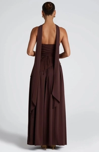 Detail view of backless maxi dress with criss-cross lace-up design and pleated skirt