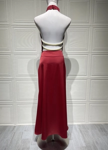 Detailed back view of a red satin halter dress with elegant pearl beaded waist accents