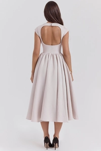 Back view of backless champagne satin midi dress with elegant pleated flared skirt