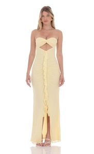 Detail of light yellow strapless maxi dress with cutout front and ruffled slit design
