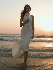 Elegant white backless satin maxi dress with halter neck for beach weddings and gala