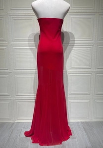Detail of elegant red strapless evening dress with slim fit and fisheye hem design