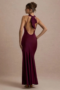Detail of elegant backless satin dress with a large bow and fishtail hemline