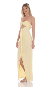 Detail of light yellow strapless maxi dress with cutout twist and ruffled side slit