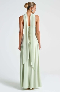 Detail of mint green backless maxi dress featuring criss-cross lace-up and long ribbons