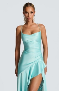 Close-up of light blue satin dress featuring ruched waist and ruffled asymmetric hem