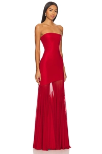Detail of red strapless evening dress with asymmetrical hem and flowing mesh fabric