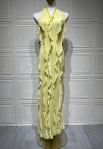 Detail of cascading ruffles on a lemon yellow sleeveless maxi dress with light fabric