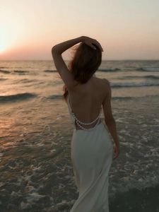 Elegant white satin backless dress featuring exquisite double-row pearl chain detailing