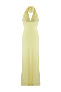 Detail of light yellow halter neck maxi dress with deep V-neck and back bow tie design