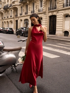 Red satin cowl neck midi dress with elegant backless design on European city street