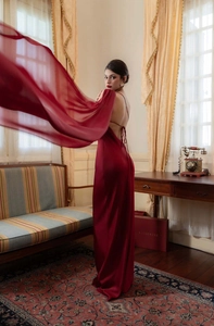 Detailed back view of backless satin dress with delicate cross straps in dark red