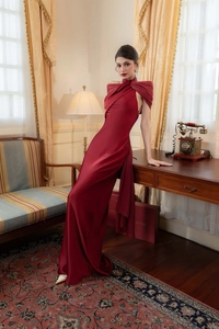 Macro view of burgundy satin dress showing elegant draped neckline and pleated detail