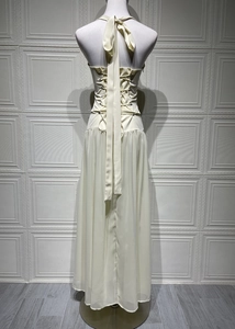 Detail view of the back tie-up waist and halter neckline of the cream maxi dress