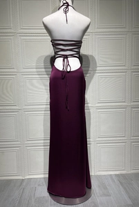 Detail of burgundy satin dress showing backless design with criss-cross lace-up straps