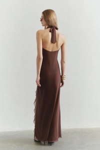 Back view of a deep brown backless halter maxi dress with layered ruffle details