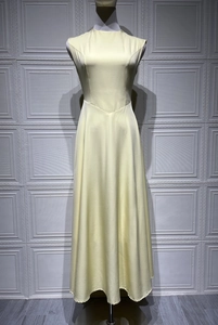 Detail of the V-shaped waist structure on a beige sleeveless elegant A-line maxi dress