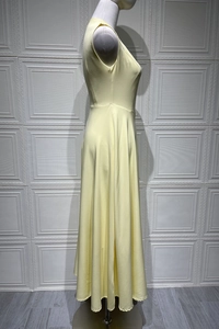 Side view of a pale yellow sleeveless A-line maxi dress with elegant waist tailoring