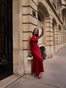 Detail of burgundy satin halter-neck dress with elegant neck tie and slim silhouette