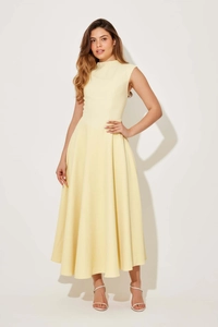 Detail of elegant pale yellow sleeveless midi dress with slim waist and flowing skirt