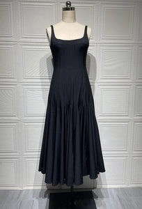 Detail of black camisole dress showing vertical pleats and flared hem on mannequin