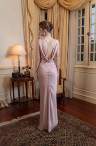 Vue arrière d'une robe longue en satin mauve avec un dos nu élégant et fluide