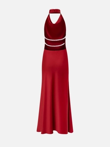 Detail of red satin halter dress showing elegant backless design and faux pearl bead rows