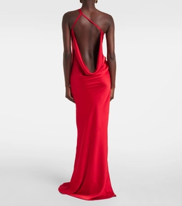 Detail view of the elegant backless design and glossy red satin fabric on long dress