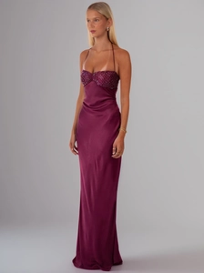 Detail of purple sequined bodice and glossy satin fabric on the long backless dress