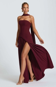 Close-up of burgundy strapless dress featuring asymmetrical waist and high side slit