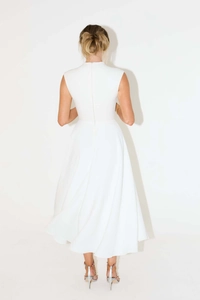 Detailed back view of white sleeveless midi dress featuring high neck and hidden zipper