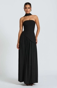 Detail of elegant black strapless dress with unique asymmetric pleated skirt and neck choker